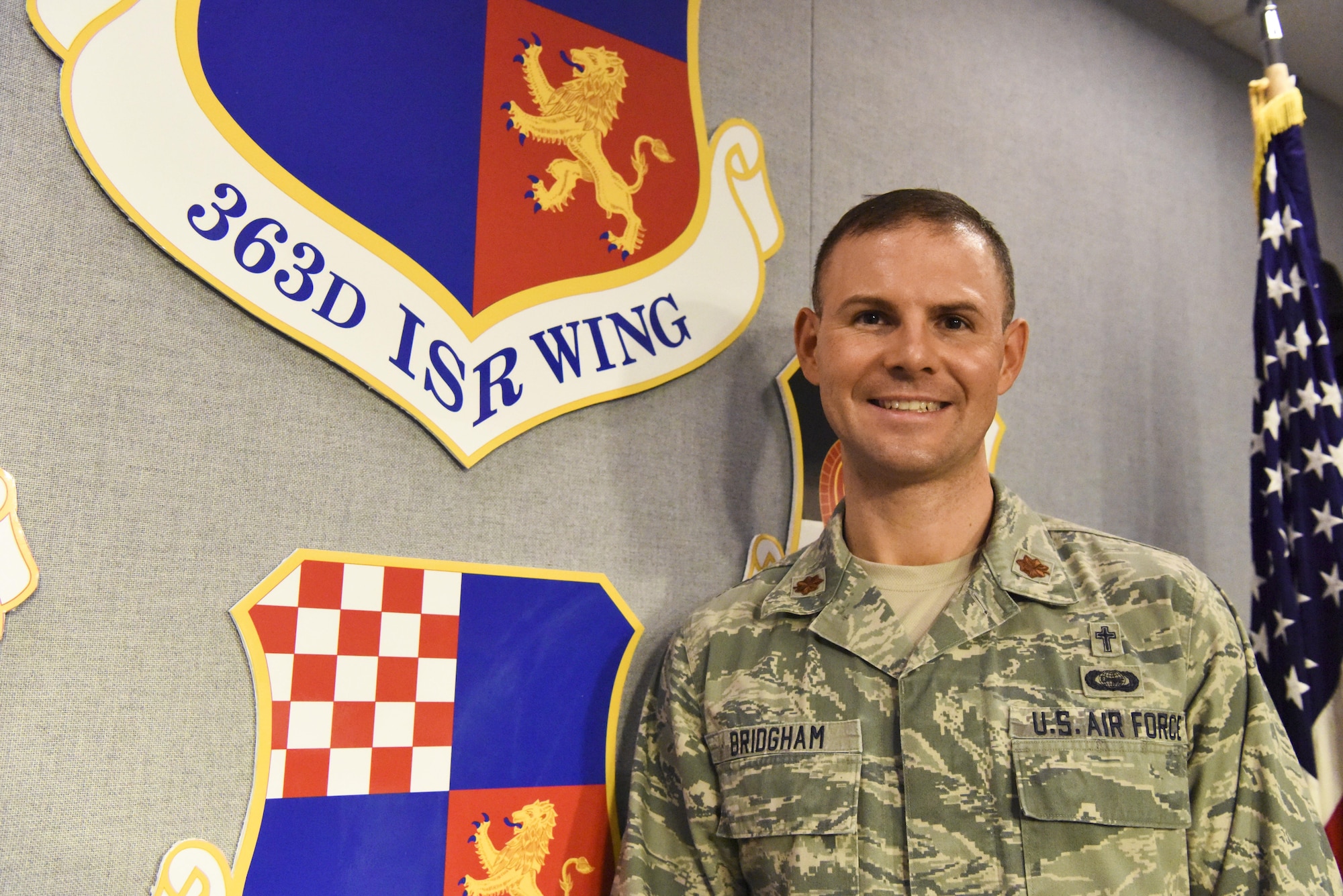 When the search for a new chaplain began at the 363rd Intelligence, Surveillance and Reconnaissance Wing, who could have imagined an ISR analyst would be selected to fill those empty shoes. Chaplain (Maj.) W. James ‘Jim’ Bridgham said he can see that his ISR career prepared him for this assignment. (U.S. Air Force photo by Technical Sgt. Darnell Cannady)
