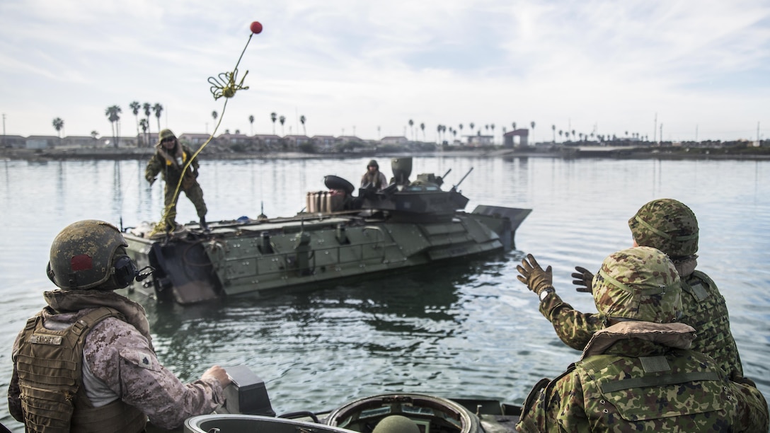 A U.S. Marine and soldiers assigned to the Japanese Ground Self-Defense Force practice recovering an assault amphibious vehicle during Exercise Iron Fist 2017 at Marine Corps Base Camp Pendleton, Calif., Feb 13, 2017. Marines taught the Japanese soldiers how to operate the amphibious vehicles. The exercise enabled U.S. and Japanese service members to share techniques, tactics and procedures to improve their combined operational capabilities. Marine Corps photo by Cpl. Alvin Pujols