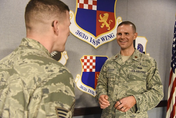 Chaplain (Maj.) W. James ‘Jim’ Bridgham speaks to an Airman at the 363rd Intelligence, Surveillance and Reconnaissance Wing at Joint Base Langley-Eustis, Virginia. (U.S. Air Force photo/Technical Sgt. Darnell Cannady)