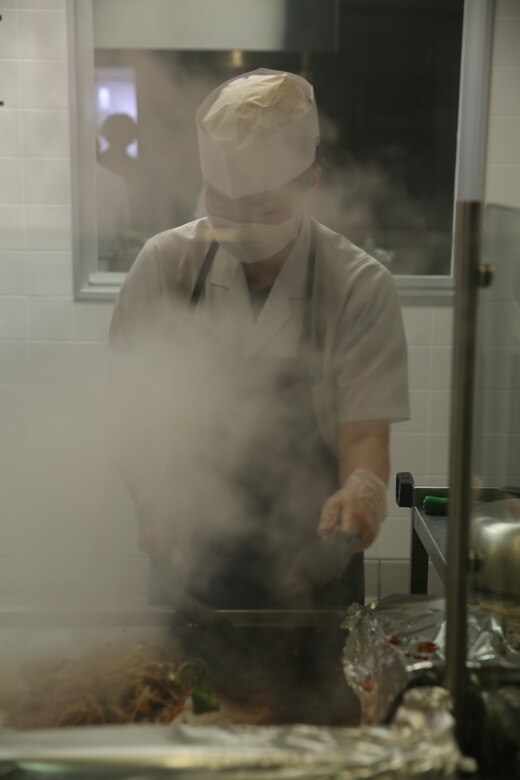 Eniko Taya, a Master Labor Contractor cook, sautés Mongolian entrée selections on the grill during Mongolian Bar Wednesday in the R.G. Robinson Mess Hall at Marine Corps Air Station Iwakuni, Japan, Feb. 8, 2017. Mongolian Bar Wednesday was started in an effort to attract more patrons to the mess halls by offering specialty meals such as the Mongolian Bowl. (U.S. Marine Corps photo by Lance Cpl. Carlos Jimenez.)