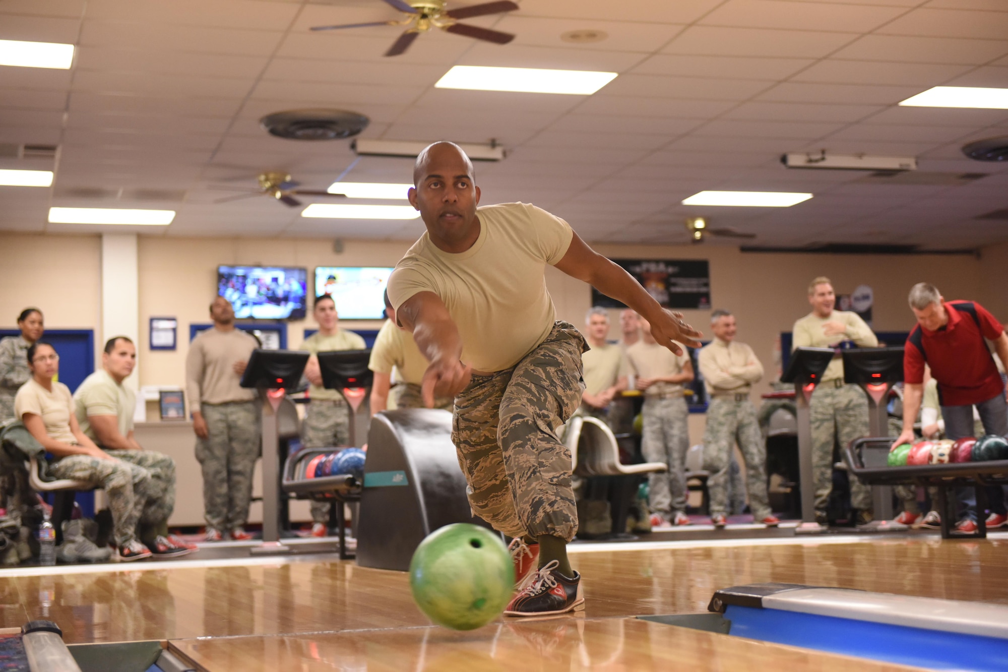 2nd Lt. Andre Jordan, 940th Force Support Squadron operations officer, rolls a bowling ball down the center of a lane as the crowd and friendly competition watches on Feb. 10, 2017 at Beale Air Force Base, Calif. Jordan participated in the 940th Air Refueling Wing’s first lunch-hour bowling competition during a unit training assembly. (U.S. Air Force by Staff Sgt. Brenda Davis/Released)