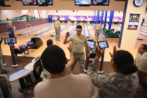 Airman John Mendiola, 940th Logistics Readiness Squadron material management, high-fives fellow teammates at the 940th Air Refueling Wing’s first lunch-hour bowling tournament hosted by first sergeants on Feb. 10, 2017 at Beale Air Force Base, Calif. Members of the wing from various units gathered at the tournament to build camaraderie and boost morale during the unit training assembly. (U.S. Air Force by Staff Sgt. Brenda Davis/Released)