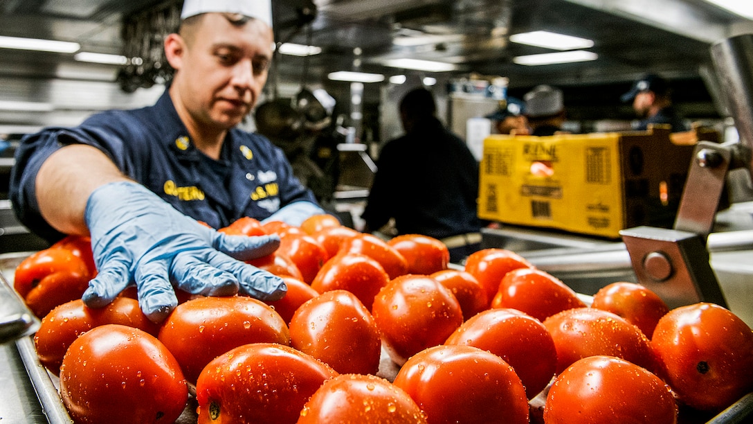 A sailor prepares food in the mess deck of the USS Lake Champlain in the Pacific Ocean, Feb. 5, 2017. The ship is part of the U.S. Pacific Fleet-led initiative to extend the command and control functions of the U.S. 3rd Fleet in the Indo-Asia-Pacific region. Navy photo by Petty Officer 2nd Class Nathan K. Serpico