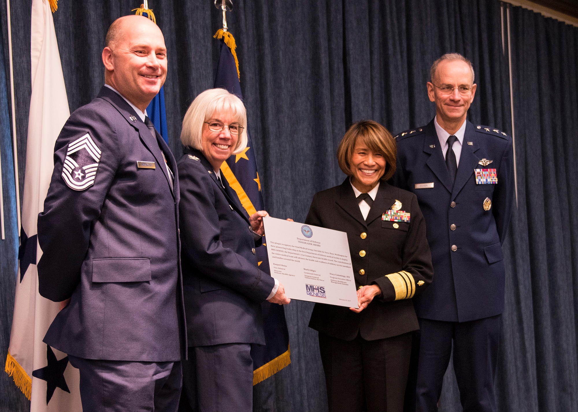 (From left to right) Chief Master Sgt. Willard Armagost, 92nd Medical Group superintendent, Col. Meg Carey, 92nd MDG commander, Navy Vice Admiral Raquel Bono, Defense Health Agency director, and Lt. Gen. Mark Ediger, U.S. Air Force surgeon general, pose with a plaque in honor of the MHS Genesis "go-live" Feb. 15, 2017, at Fairchild Air Force Base, Wash. MHS Genesis is a Department of Defense wide initiative to move to an all digital, networked medical record system. (U.S. Air Force photo/Airman 1st Class Ryan Lackey)