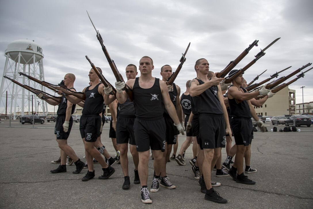 Marines with the Marine Corps Silent Drill Platoon executes the “bursting bomb” during a portion of their month-long training phase as a part of the Marine Corps Battle Color Detachment (BCD) aboard Marine Corps Air Station Yuma, Az., Feb. 10, 2017. The BCD is comprised of the Marine Corps Silent Drill Platoon, “The Commandant’s Own,” the United States Marine Drum & Bugle Corps and the Marine Corps Color Guard. The unit’s overall mission while training aboard MCAS Yuma, is to hone and perfect their precision drill movements and musical ballads for not only the coming West and East Coast tours, but as well as the ceremonial duties they are tasked with year-round as units of Marine Barracks Washington. (Official Marine Corps photo by Cpl. Robert Knapp/Released)