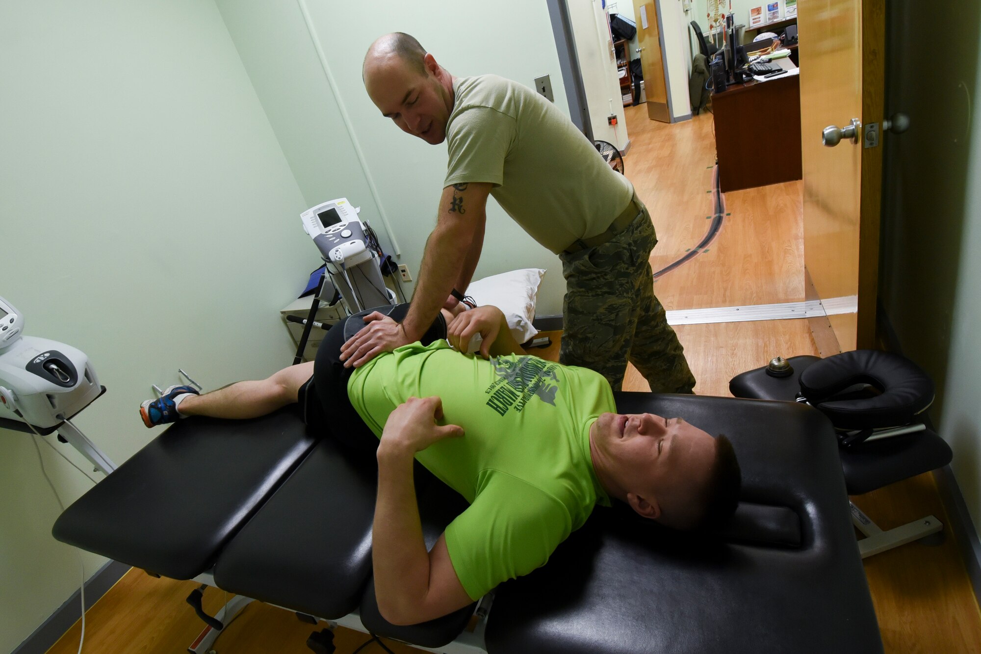 U.S. Air Force Senior Airman Jacob Schackman, 8th Maintenance Squadron Precision Measurement Equipment Laboratory technician, is assisted by Master Sgt. Gregory Dorner, 8th Medical Operations Squadron Physical Therapy flight chief, with stretching during his physical therapy appointment at Kunsan Air Base, Republic of Korea, Feb. 14, 2017. Schackman, who is recovering from an off-duty injury, practices assisted stretching as part of his rehabilitation. (U.S. Air Force photo by Senior Airman Michael Hunsaker/Released)