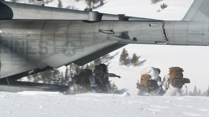 Marines with 2nd Battalion, 2nd Marine Regiment, 2nd Marine Division, quickly exit a CH-53E Super Stallion with Marine Heavy Helicopter Squadron (HMH) 462 during on and offloading insertion drills at Marine Corps Mountain Warfare Training Center, Bridgeport, California, Feb. 4. Mountain Exercise training is an important function to ensure Marines are prepared to operate in any climate. 