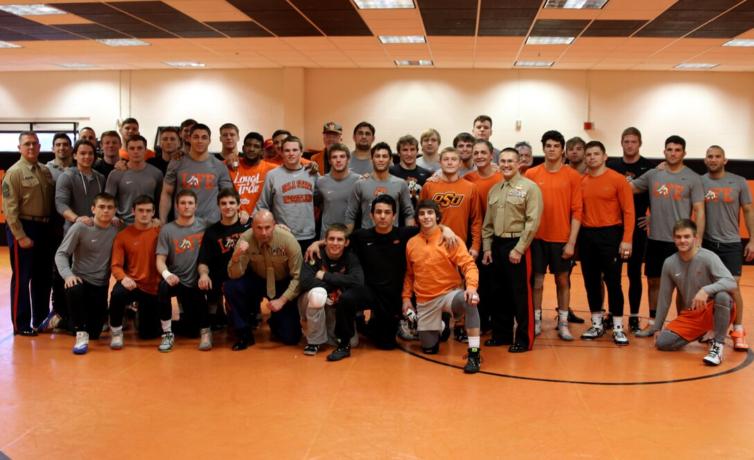 U.S. Marine Corps Director of Intelligence Brig. Gen. William H. Seely III, far right, and  Recruiting Station Oklahoma City Sgt. Maj. John A. Thompson, III, left, and Maj. Ryan Cohen, middle, visited the Oklahoma State University wrestling team at the Gallagher-Iba Arena, Feb. 15.  Brig. Gen. Seely, an OSU alumni, visited the NCAA Division I number one ranked Cowboys to motivate and inspire them before their National Wrestling Coaches Association (NWCA) National Duals Final, Feb. 19, against number two ranked Pennsylvania State University. 
