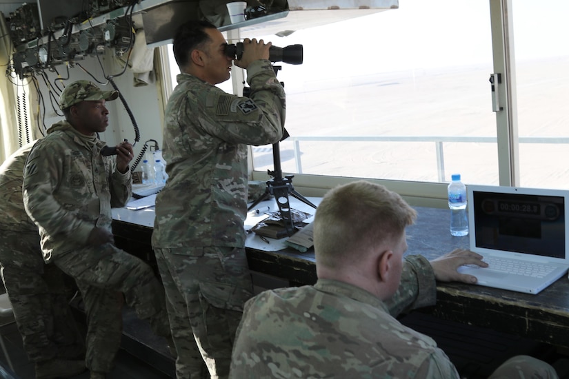 Staff Sgt. Gregory Jones (left) and Spc. Hector Frungvez (right) 2nd Engineer Battalion, 3rd Army Brigade Combat Team, 1st Armored Division and Sgt. 1st Class Stanley Osinisky (center), Headquarters and Headquarters Company, 123rd Brigade Combat Battalion call and confirm notional enemy targets during Stryker gunner day iteration Feb. 9, 2015 at Camp Beuring, Kuwait.