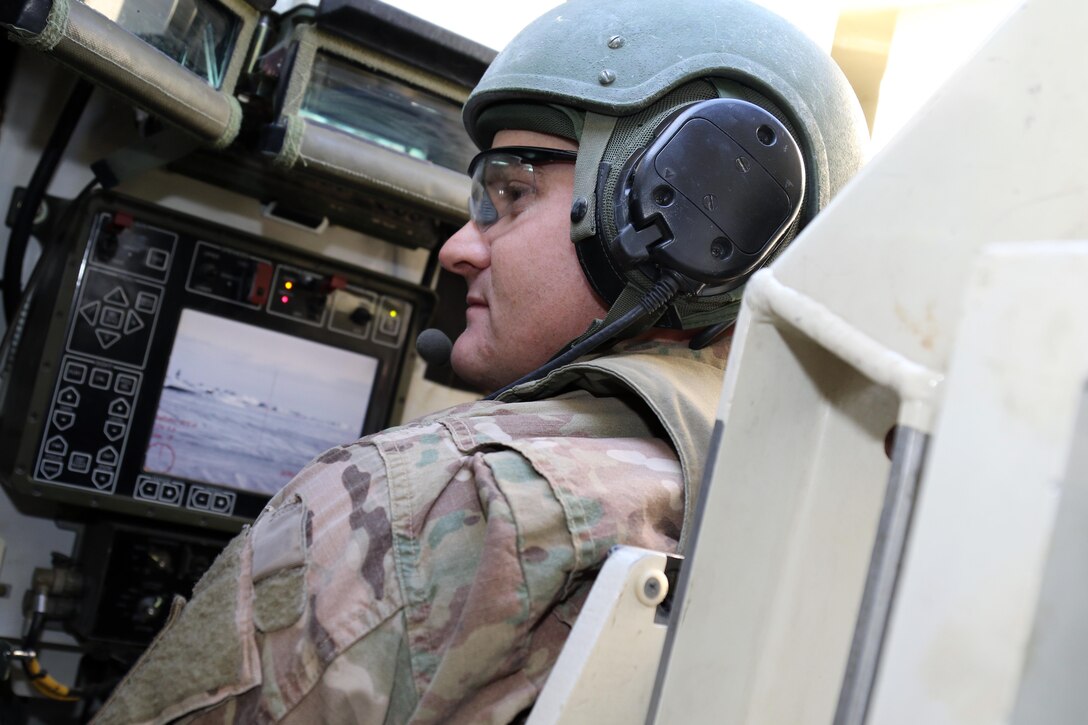 Sgt. Stephen Lamb, Headquarters and Headquarters, 2nd Engineer Battalion, 3rd Infantry Division acknowledges directions he is receiving from his assistance gunner before firing at a Stryker gunner day qualification Feb. 9, 2017 in Camp Beuring, Kuwait. Lamb, a native of Tyler, Texas, accredited each crew member's capabilities to teamwork.