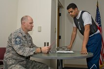 U.S. Air Force Reserve Senior Master Sgt. Kevin Smith, SNCO for sustainment services, 913th Force Support Squadron, checks fitness paperwork for Staff Sgt. Angel Gonzalez, material manager, 913 FSS, Feb. 12, 2017, at Little Rock Air Force Base, Ark. The Air Force uses an overall composite fitness score and minimum scores per component based on aerobic fitness (1.5-mile times run), body composition (Abdominal circumference measurements) and muscular fitness components (pushups and sit-ups) to determine overall fitness. (U.S. Air Force photo by Master Sgt. Jeff Walston/Released)