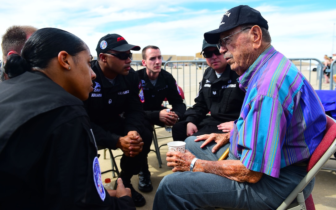 Walter Ram, former World War II Prisoner of War, speaks with members of the F-22 Raptor Demonstration Team during the 2017 Heritage Flight Training and Certification Course at Davis-Monthan Air Force Base, Ariz., Feb. 11, 2017. The team members had the opportunity to speak with Ram and learn of his time in service as well as when he was captured. (U.S. Air Force photo by Senior Airman Kimberly Nagle)