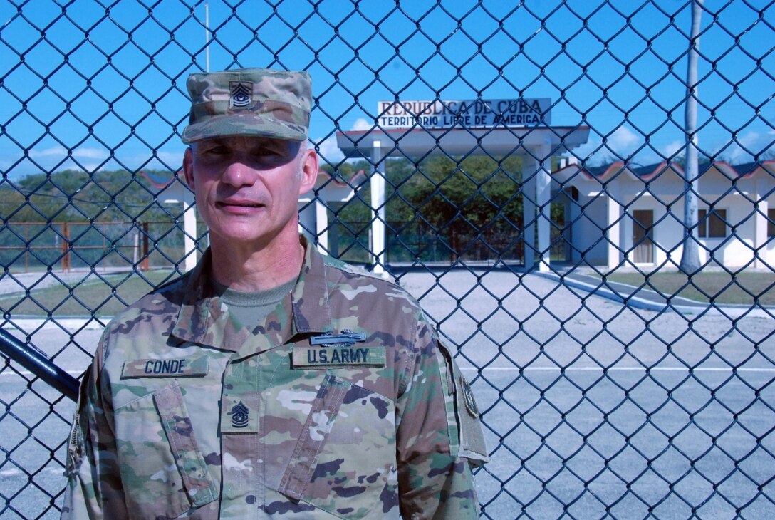 Command Sgt. Maj. Rafael Conde, the Wisconsin Army National Guard’s senior enlisted leader, stands by the northeast gate at Naval Station Guantanamo Bay, Cuba, Dec. 30, 2016. Conde was born in Cuba and fled to the United States as a child with his family. He returned to Cuba as part of an official visit led by Wisconsin Gov. Scott Walker and Maj. Gen. Don Dunbar, Wisconsin’s adjutant general, to visit with members of the Wisconsin Army National Guard’s 32nd Military Police Company deployed to Guantanamo Bay. Wisconsin National Guard photo