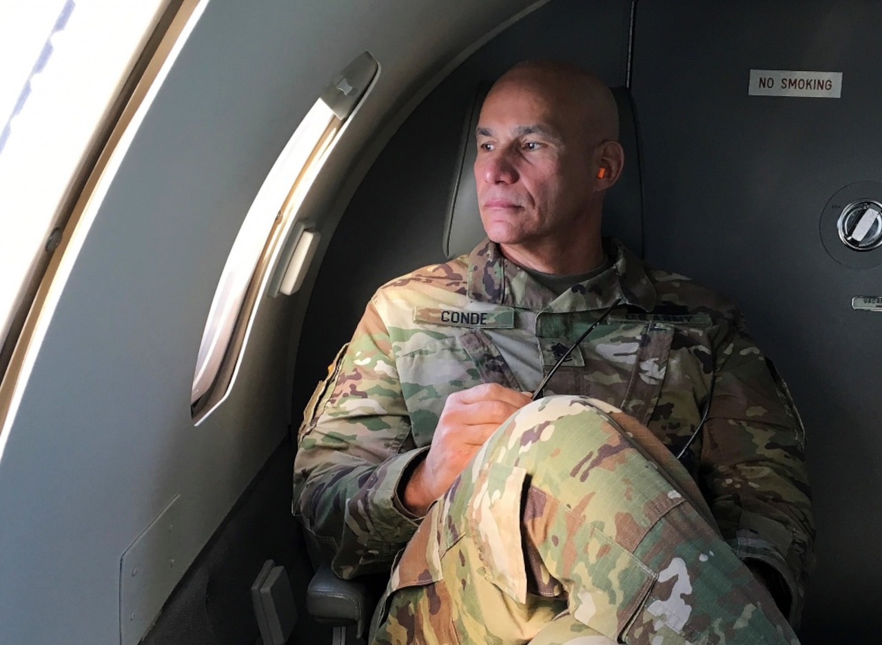 Command Sgt. Maj. Rafael Conde, the Wisconsin Army National Guard’s senior enlisted leader, gets his first look at Naval Station Guantanamo Bay, Cuba, during final approach, Dec. 28, 2016. Conde was born in Cuba and fled to the United States as a child with his family. He returned to Cuba as part of an official visit led by Wisconsin Gov. Scott Walker and Maj. Gen. Don Dunbar, Wisconsin’s adjutant general, to visit with members of the Wisconsin Army National Guard’s 32nd Military Police Company deployed to Guantanamo Bay. Wisconsin National Guard photo