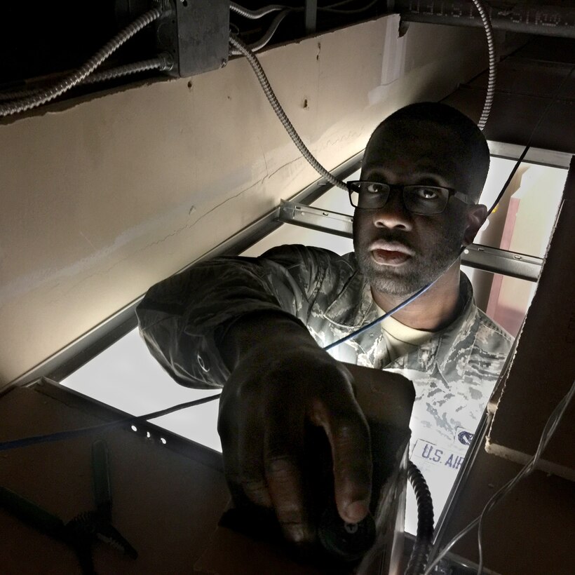 Senior Airman Emmanuel Thompson, 514th Civil Engineer Squadron, Air Force Reserve Command, installs an outlet as part of a renovation project at the Wing headquarters building at Joint Base McGuire-Dix-Lakehurst, N.J., Feb. 12, 2017. (U.S. Air Force photo by Master Sgt. Mark C. Olsen/Released)