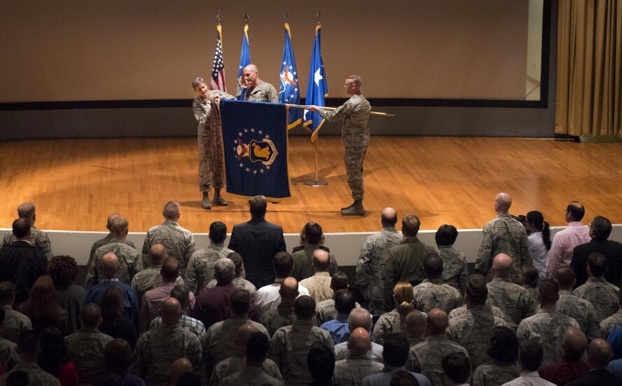 Gen. Ellen M. Pawlikowski, the Air Force Materiel Command commander, secures the newest award ribbon to the 96th Test Wing guidon at her Commander’s Call Feb. 14 at Eglin Air Force Base, Fla.  Wing leadership officially received the Outstanding Unit citation from Pawlikowski during the event.  The general spent two days at the base receiving updates on the various programs occurring in her various AFMC units.  (U.S. Air Force photo/Samuel King Jr.)