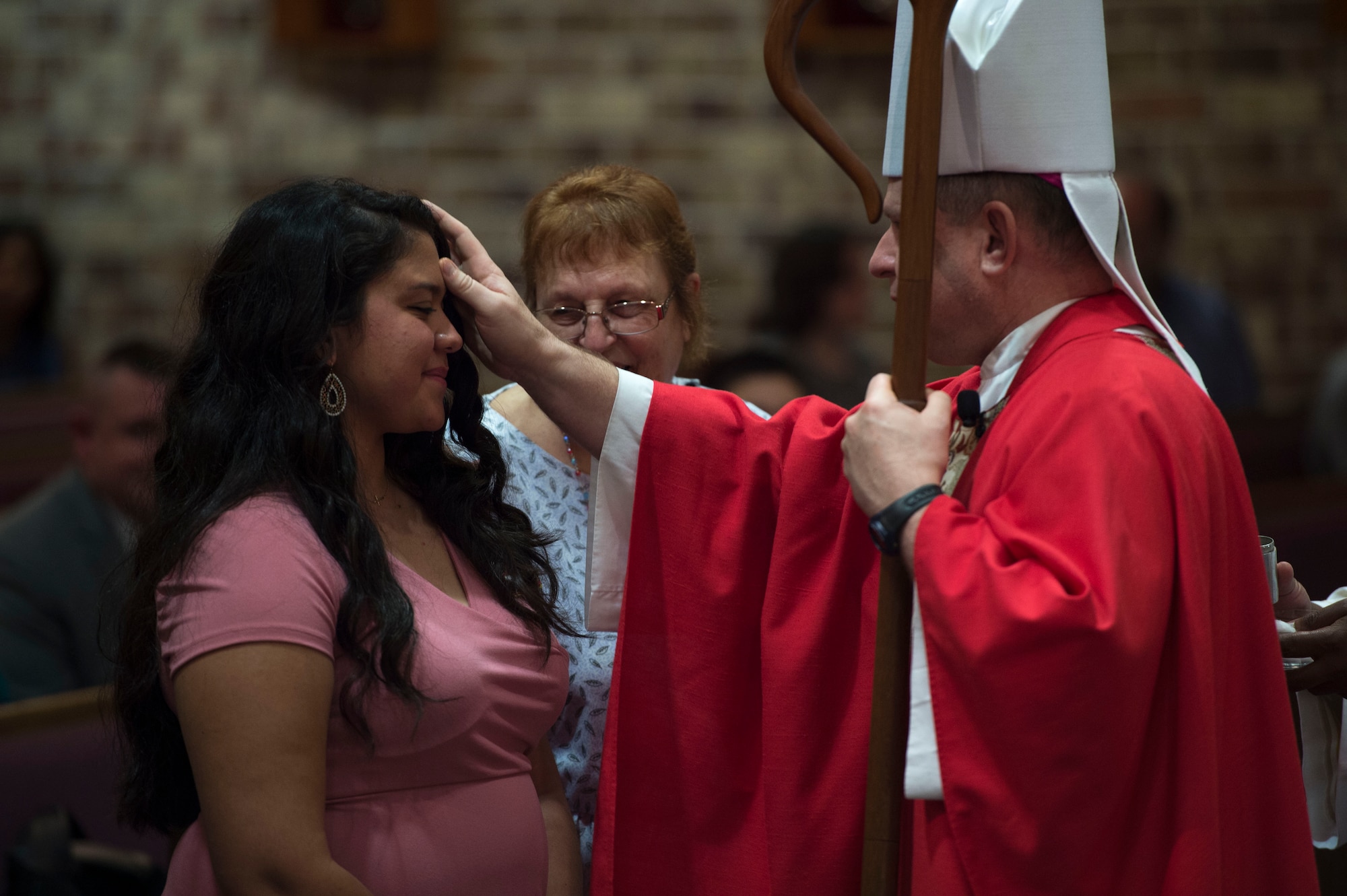 Bishop Robert Coyle, Archdiocese for the Military Service, anoints a member of the congregation, during Confirmation Mass, Feb. 14, 2017, at Moody Air Force Base, Ga. Pope John Paul II created the Archdiocese for the Military Services in 1985 to provide the Catholic Church's full range of pastoral ministries and spiritual services to those in the United States Armed Forces. The Archbishop for the Military Services is responsible for the spiritual welfare of more than 1.8 million men, women and children. (U.S. Air Force photo by Andrea Jenkins)