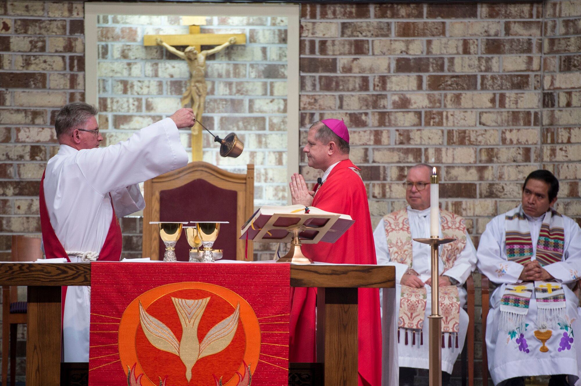 Deacon Peter Falkenhausen, 23d Wing Safety, blesses Bishop Robert Coyle, Archdiocese for the Military Service, during Confirmation Mass, Feb. 14, 2017, at Moody Air Force Base, Ga. Pope John Paul II created the Archdiocese for the Military Services in 1985 to provide the Catholic Church's full range of pastoral ministries and spiritual services to those in the United States Armed Forces. The Archbishop for the Military Services is responsible for the spiritual welfare of more than 1.8 million men, women and children. (U.S. Air Force photo by Andrea Jenkins)