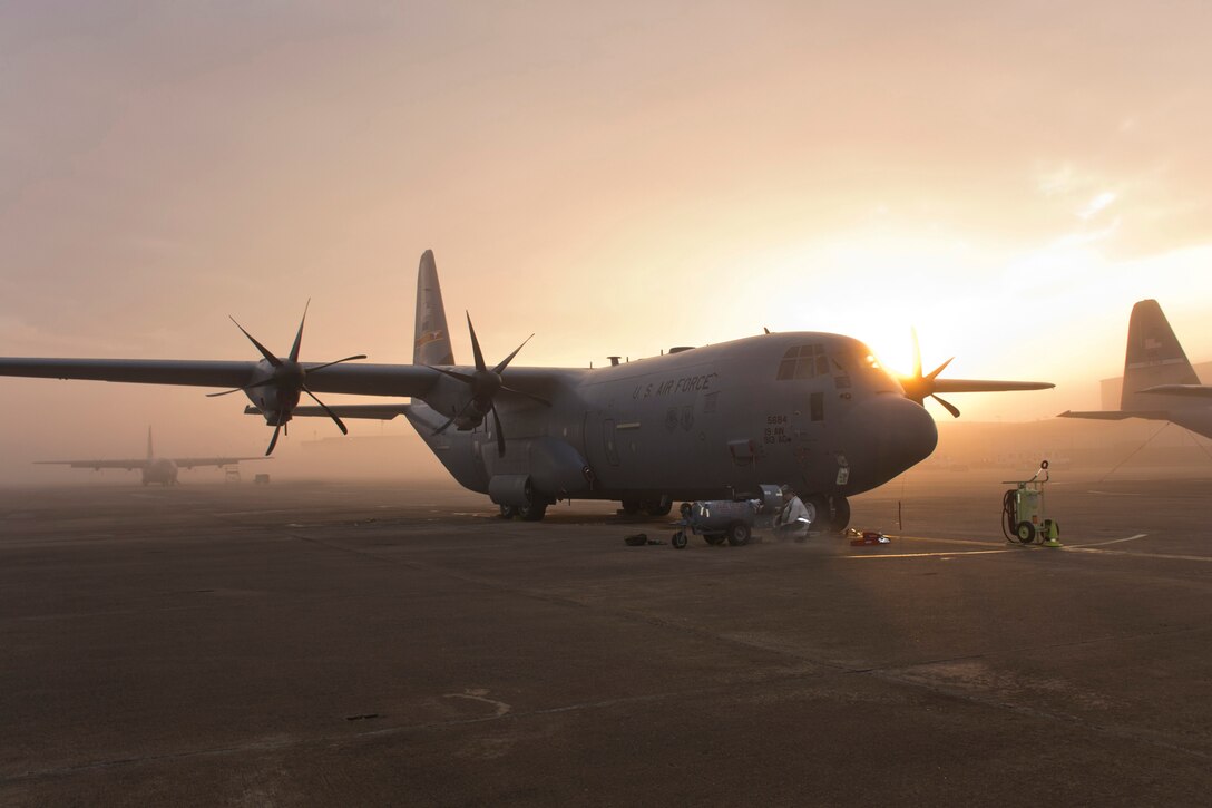 U.S. Air Force Airman 1st Class James Poole, aerospace maintenance apprentice, 19th Aircraft Maintenance Squadron, prepares to fill the oxygen system of a C-130J Super Hercules as the Sun peaks through the fog Feb 12, 2017, at Little Rock Air Force Base, Ark. This particular C-130, which bears the tail flash of the 913th Airlift Group, was designated as a back-up for another aircraft being prepared to go off-station. (U.S. Air Force photo by Master Sgt. Jeff Walston/Released)