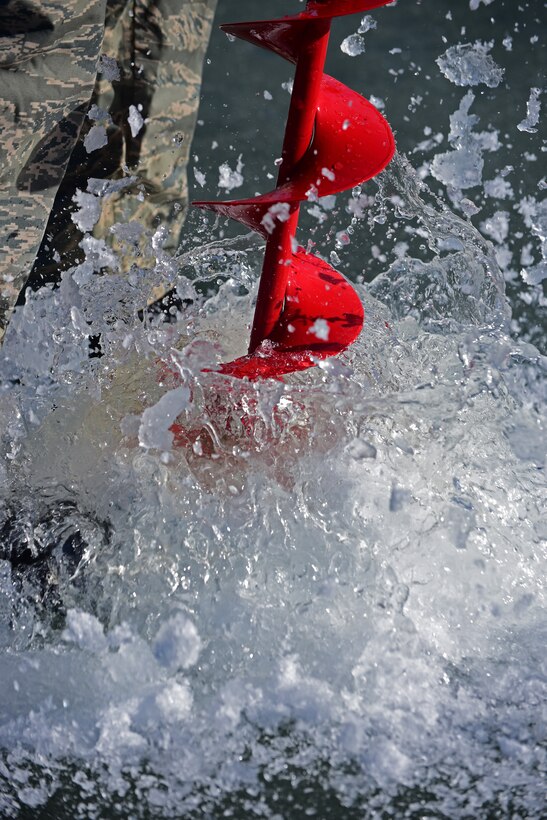 An auger rips through ice allowing water levels to be measured at Ellsworth Air Force, S.D., Feb. 14, 2017. Airmen from the 28th Civil Engineer Squadron took measurements of water and silt levels to determine if the lake bed needed to be expanded. (U.S. Air Force photo by Senior Airman James L. Miller)