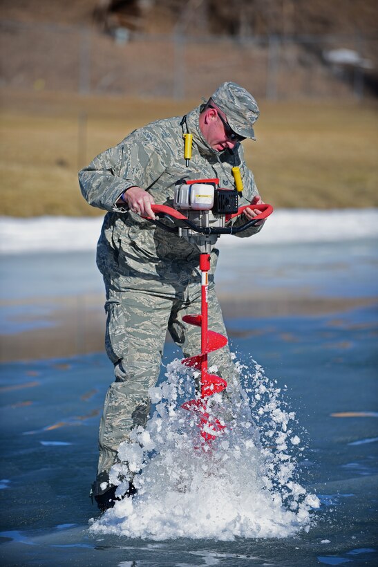 Tech. Sgt. Teddy Wagoner, a program management non-commissioned officer in charge assigned to the 28th Civil Engineer Squadron, drills a hole through an iced over lake at the Prairie Ridge golf course, in Box Elder, S.D., Feb. 14, 2017. Drilling through the ice allows water level measurements to be taken and compared through different seasons. 