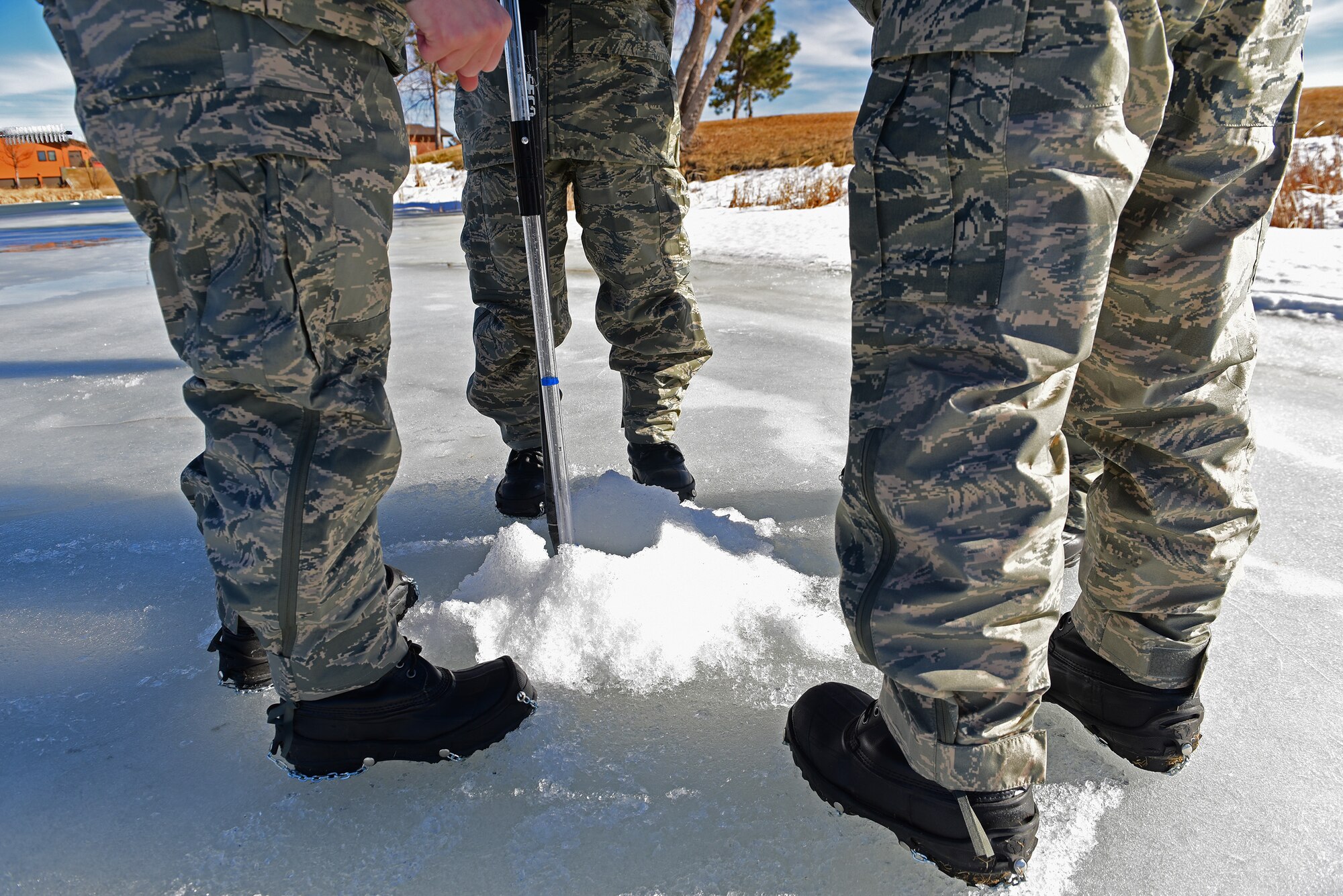 Airmen from the 28th Civil Engineer Squadron use different tools, such as a sledge pole, auger and survey equipment to gather information from water levels of a lake at Prairie Ridge golf course, in Box Elder, S.D., Feb. 14, 2017. The Airmen used this opportunity to not only complete a project, but also acquire proficiency with each piece of equipment used. (U.S. Air Force photo by Senior Airman James L. Miller)  