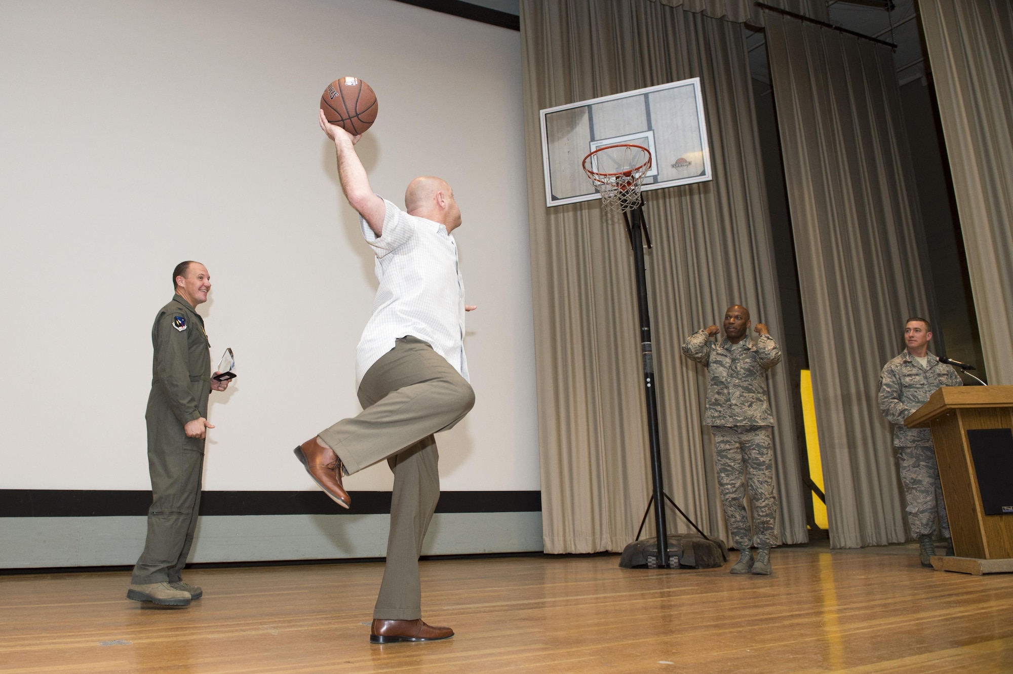 Mike Sears, 412th Logistics Readiness Squadron director, attempts to score a bucket at the Base Theater during the 412th Test Wing 4th Quarter Awards Ceremony Feb. 13. (U.S. Air Force photo by Kyle Larson)