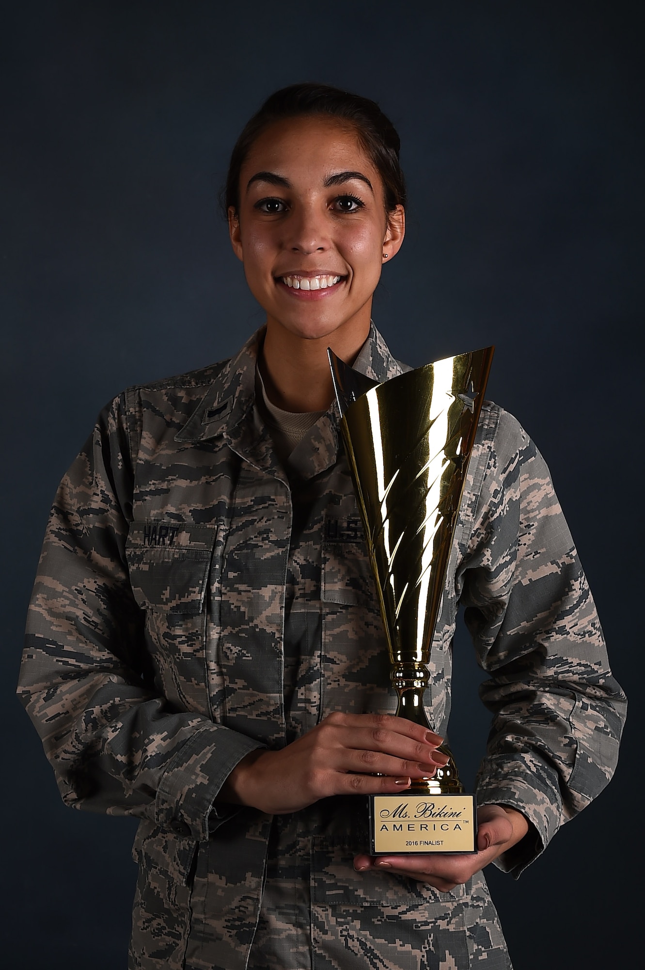 1st Lt. Jamielynn Hart, 2nd Space Warning Squadron deputy flight commander and space operations center commander, stands with her Fitness America fourth place trophy Jan. 11, 2016, on Buckley Air Force Base, Colo. Fitness America, an international fitness competition, in which Hart placed fourth in the 18 to 30, tall bikini competition. (U.S. Air Force photo by Airman 1st Class Gabrielle Spradling/Released)