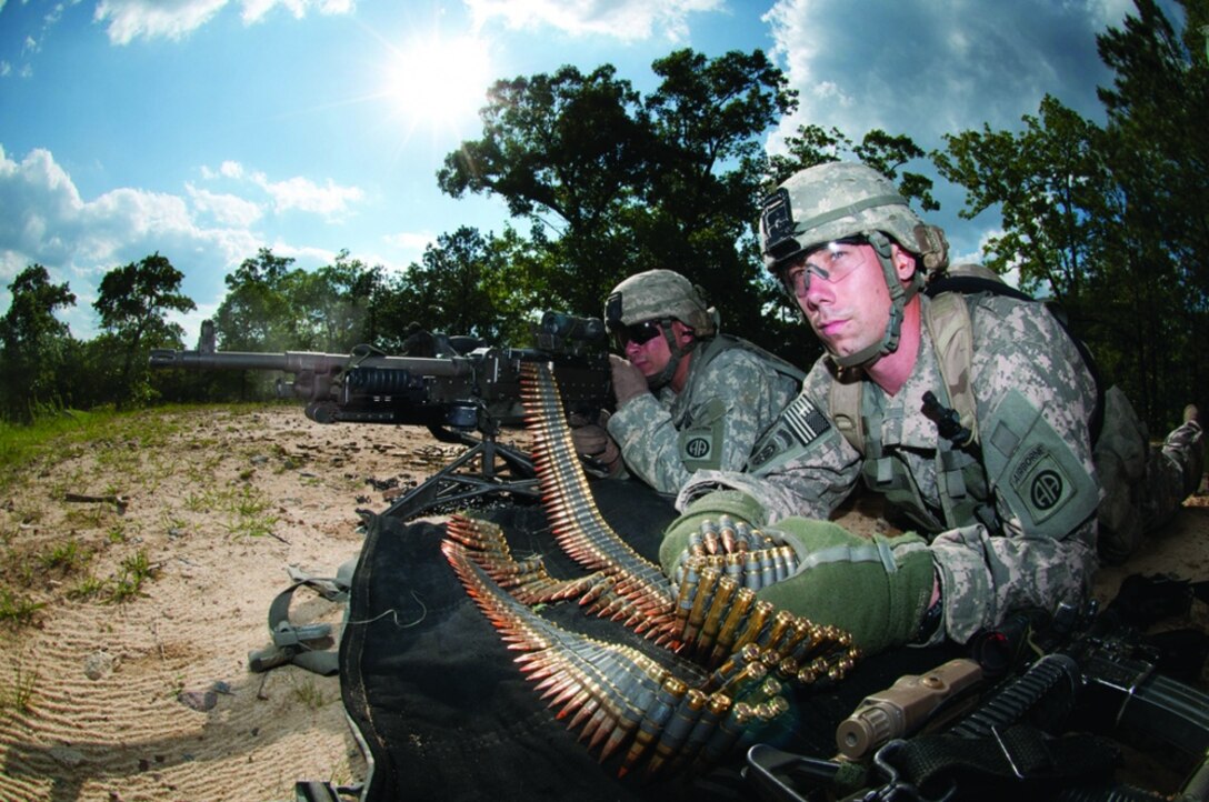 Army Spc. Robert Woodworth feeds ammunition to Army Spc. John Thrasher’s M240B machine gun as the two help to provide covering fire for their platoon during the assault on an enemy position that was part of a war-game exercise held at Fort Bragg, N.C., May 4, 2011. The Army’s ammunition community will benefit from a new, improved automated information system that is more secure, transparent and user-friendly. Army photo by Terrance Bell