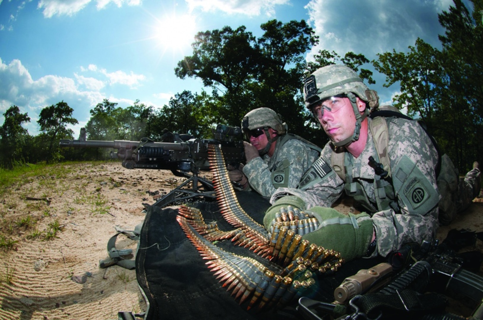 Army Spc. Robert Woodworth feeds ammunition to Army Spc. John Thrasher’s M240B machine gun as the two help to provide covering fire for their platoon during the assault on an enemy position that was part of a war-game exercise held at Fort Bragg, N.C., May 4, 2011. The Army’s ammunition community will benefit from a new, improved automated information system that is more secure, transparent and user-friendly. Army photo by Terrance Bell