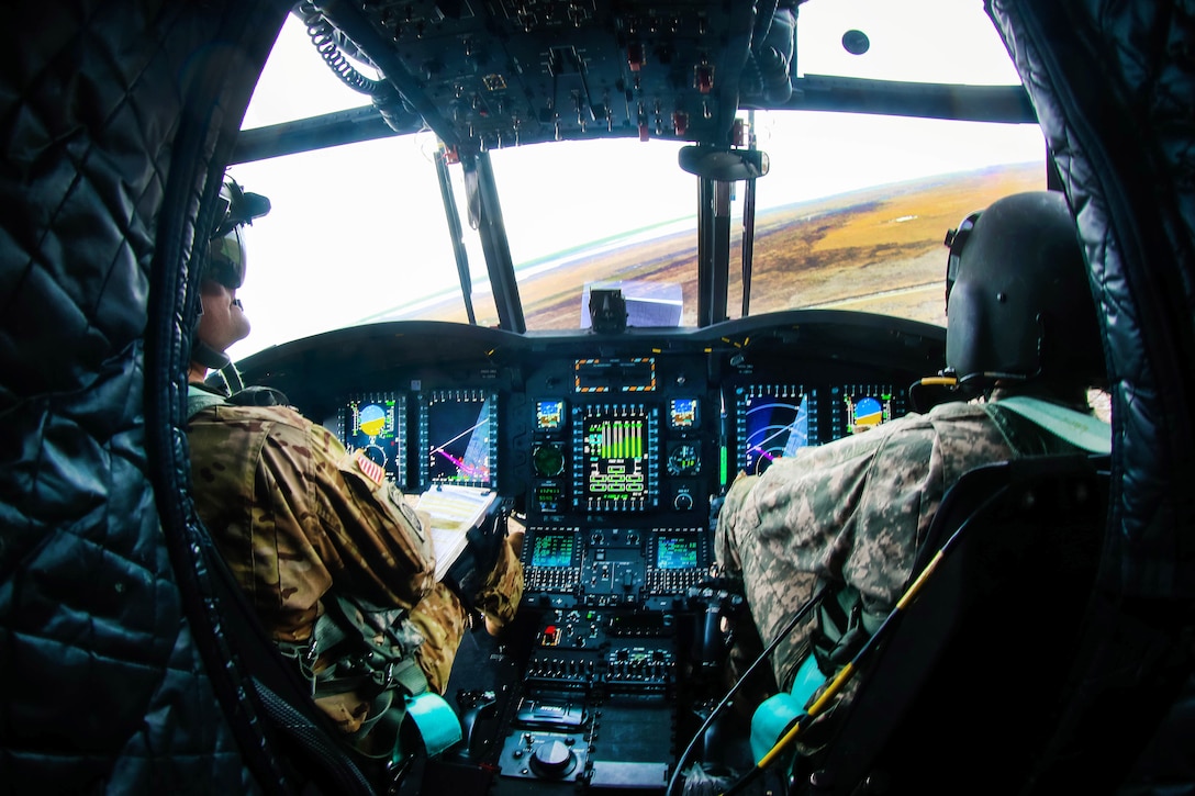 Army pilots maneuver a CH-47 Chinook helicopter so machine gunners have a better firing view of a target during an aerial gunnery training exercise at Marine Corps Outlying Field Atlantic, N.C., Feb. 8, 2017. Army photo by Army Sgt. Steven Galimore