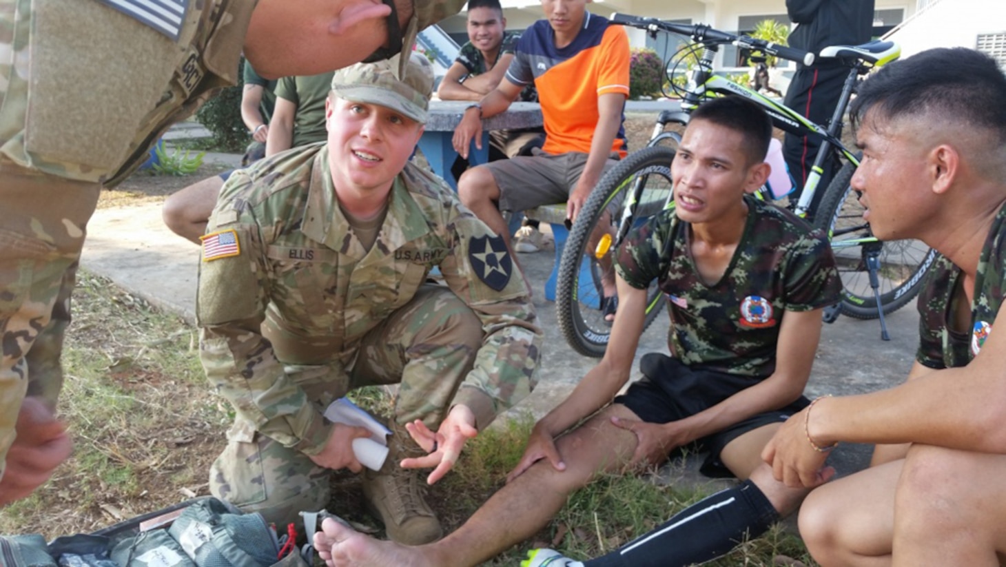 U.S. Army Pvt. Michael Ellis, B. Co., 1st Battalion, 23rd Infantry medic (second from right), discusses treatment procedures for an injured Royal Thai soldier with another medic, Feb. 12, at Camp Suratham Phithak, Korat, Thailand. The Royal Thai soldier injured his leg during a friendly soccer match with 23rd Infantry Regiment soldiers as part of Cobra Gold 2017’s field training exercise (FTX) opening ceremony celebration. The upcoming FTX provides a venue for Thai, U. S. and partner nations to advance interoperability and increase partner capacity in planning and executing complex and realistic, multinational force and combined task force operations. 