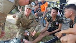 U.S. Army Pvt. Michael Ellis, B. Co., 1st Battalion, 23rd Infantry medic (second from right), discusses treatment procedures for an injured Royal Thai soldier with another medic, Feb. 12, at Camp Suratham Phithak, Korat, Thailand. The Royal Thai soldier injured his leg during a friendly soccer match with 23rd Infantry Regiment soldiers as part of Cobra Gold 2017’s field training exercise (FTX) opening ceremony celebration. The upcoming FTX provides a venue for Thai, U. S. and partner nations to advance interoperability and increase partner capacity in planning and executing complex and realistic, multinational force and combined task force operations. 