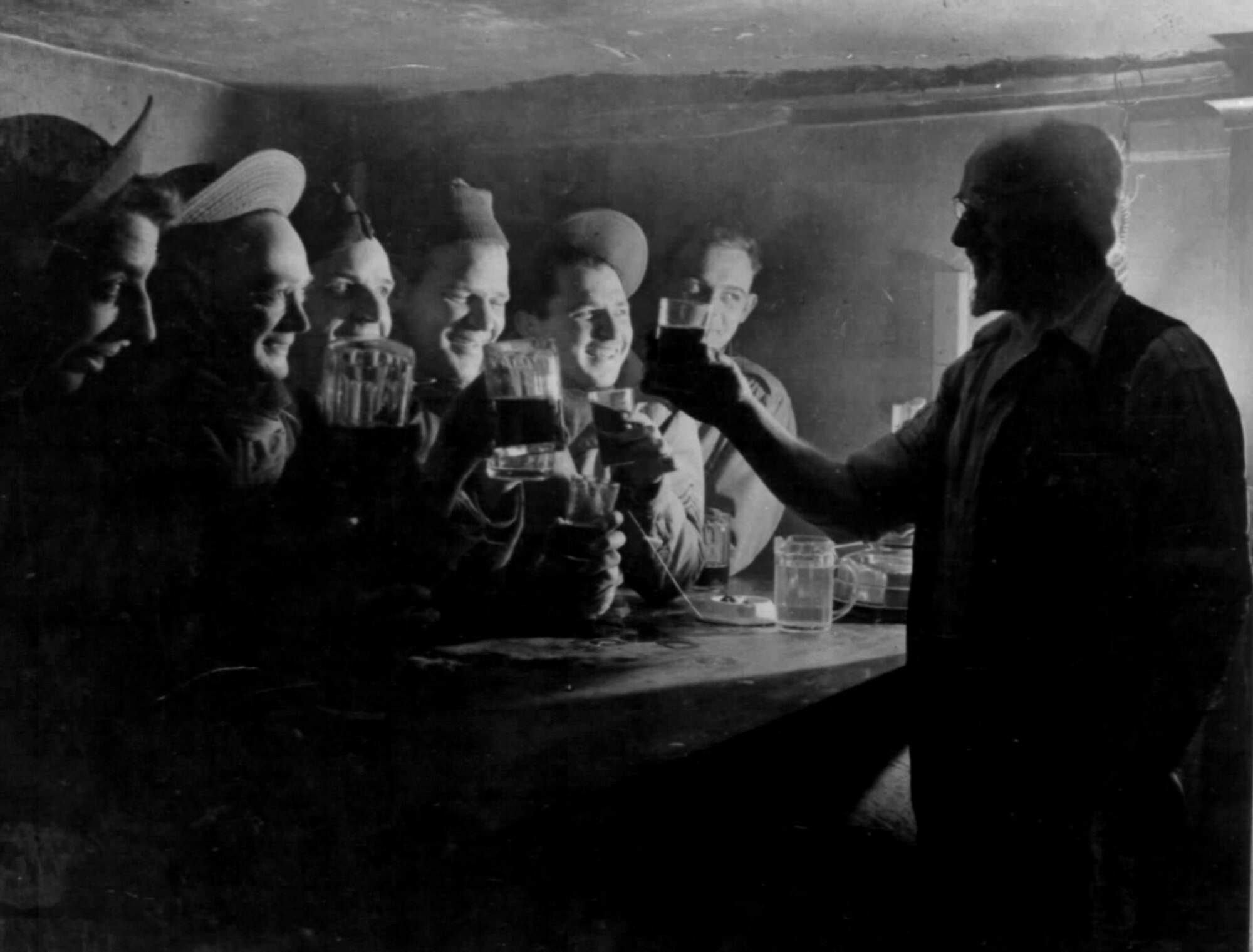 Publican “Pop” Potter raises a glass to Airmen of the 55th Fighter Group inside of the Woodman Inn pub located at Nuthampstead, England, during the World War II. The pub was located within the United States Army Air Force’s post 131 border and was visited by American Airmen during their brief stay at Nuthampstead. (Ucourtesy photo from Russ Abbey)