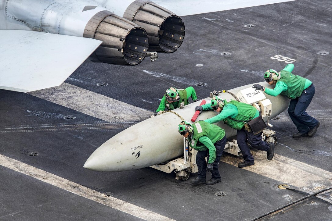 Sailors move a fuel pod on the aircraft carrier USS Carl Vinson in the Pacific Ocean, Feb. 9, 2017. The ship is part of the U.S. Pacific Fleet-led initiative to extend the command and control functions of U.S. 3rd Fleet. The sailors are assigned to Strike Fighter Squadron 2. Navy Photo by Petty Officer 2nd Class Sean M. Castellano