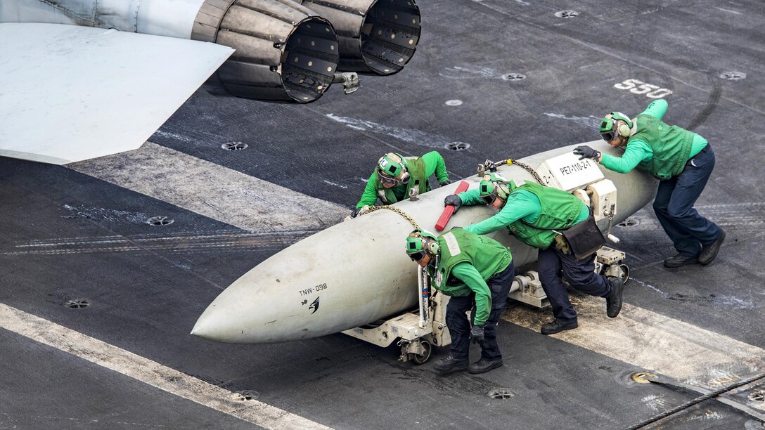 Sailors move a fuel pod on the aircraft carrier USS Carl Vinson in the Pacific Ocean, Feb. 9, 2017. The ship is part of the U.S. Pacific Fleet-led initiative to extend the command and control functions of U.S. 3rd Fleet. The sailors are assigned to Strike Fighter Squadron 2. Navy Photo by Petty Officer 2nd Class Sean M. Castellano