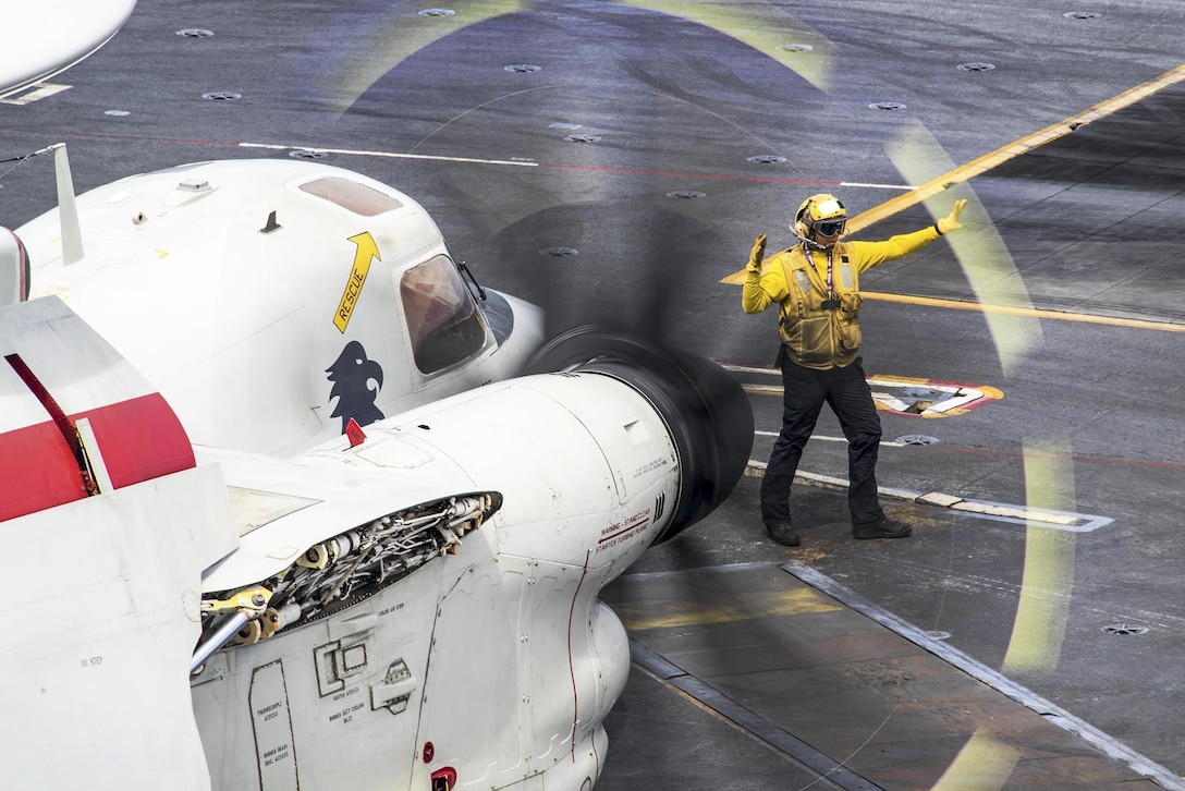 Navy Petty Officer 3rd Class Sarah Melendez directs an E-2C Hawkeye aircraft on the flight deck of the aircraft carrier USS Carl Vinson in the Pacific Ocean, Feb. 9, 2017. Melendez is an aviation boatswain’s mate. Navy photo by Petty Officer 2nd Class Sean M. Castellano