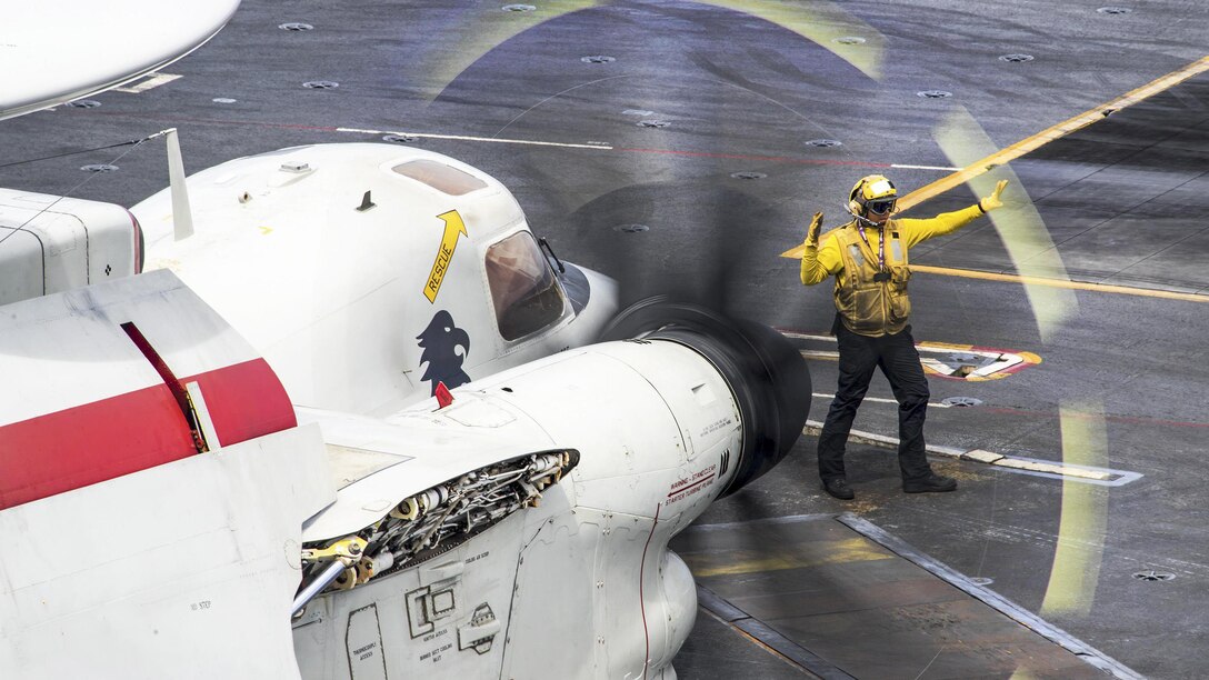 Navy Petty Officer 3rd Class Sarah Melendez directs an E-2C Hawkeye aircraft on the flight deck of the aircraft carrier USS Carl Vinson in the Pacific Ocean, Feb. 9, 2017. Melendez is an aviation boatswain’s mate. Navy photo by Petty Officer 2nd Class Sean M. Castellano