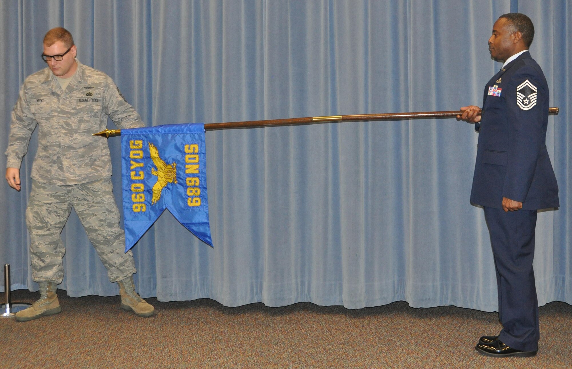 The 689th Network Operations Squadron’s guidon is unfurled during an activation and Assumption of Command ceremony Feb. 12, at Gunter Annex. The 689th is now commanded by Maj. Kevin Deibler and is the Air Force’s newest unit in the Cyber Fight. (U.S. Air Force photo by Bradley J. Clark)