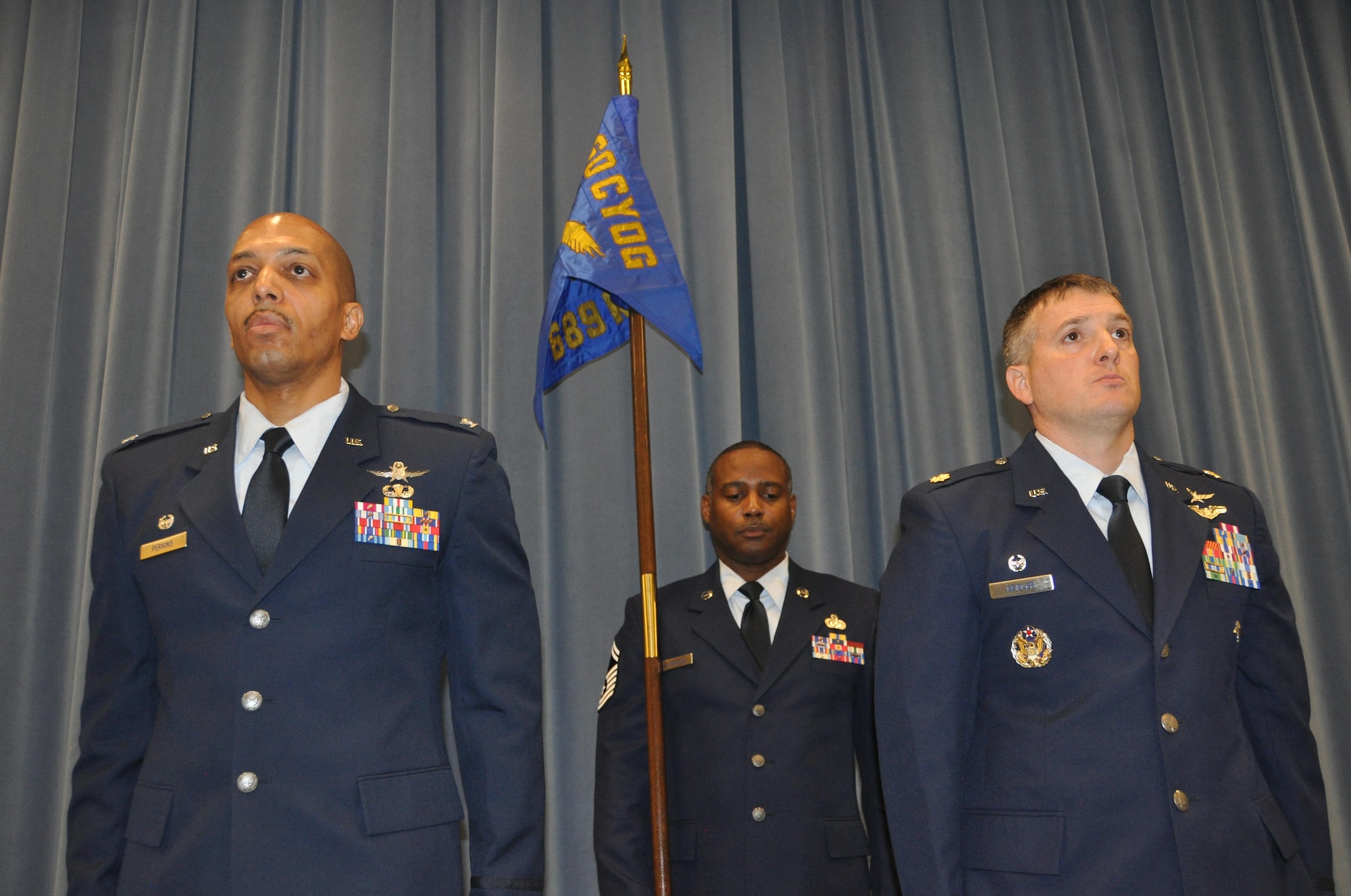 Commander of the 960th Cyberspace Operations Group, Col. Anthony Perkins, left, and Maj. Kevin Deibler, commander of the 689th Networks Operations Squadron, participate in an Assumption of Command ceremony Feb. 12, at Gunter Annex. The 689th is the Air Force’s newest Net Ops Squadron in the Cyber fight. (U.S. Air Force photo by Bradley J. Clark)