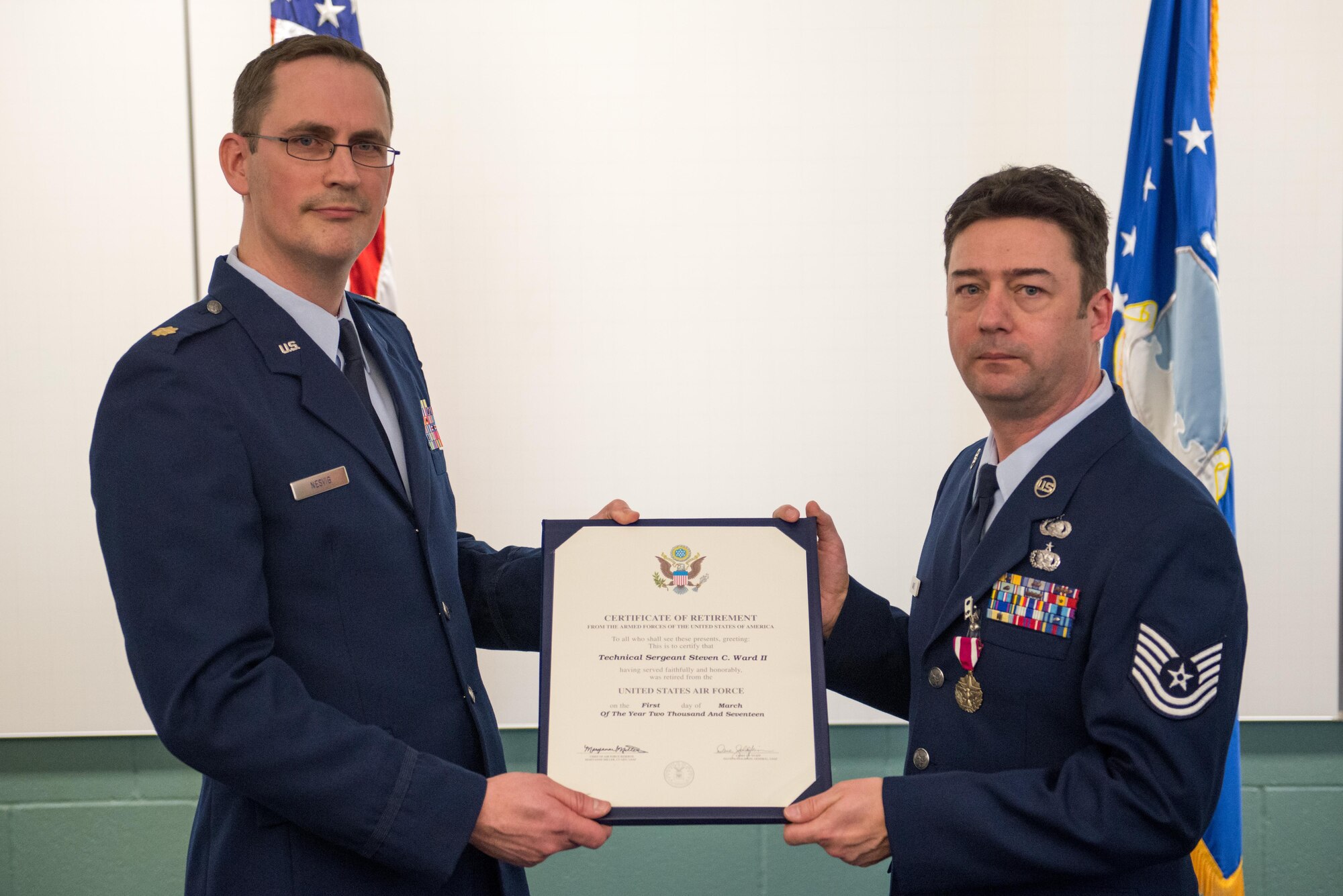 Maj. Mark Nesvig, 934th Logistics Readiness Squadron commander, presents Tech. Sgt. Steven Ward with his retirement certificate Feb. 11 during the monthly Unit Training Assembly.