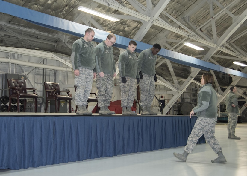 Airmen from the 11th Civil Engineer Squadron measure place markers for Air Force leadership at Joint Base Andrews, Md., Feb. 16, 2017. In addition to setting up a stage, the 11th CES arranged chairs, bleachers and flags in preparation for the Chief Master Sergeant of the Air Force Transition Ceremony, during which the 18th Chief Master Sergeant of the Air Force, Kaleth O. Wright, will be appointed. (U.S. Air Force photo by Senior Airmen Jordyn Fetter)