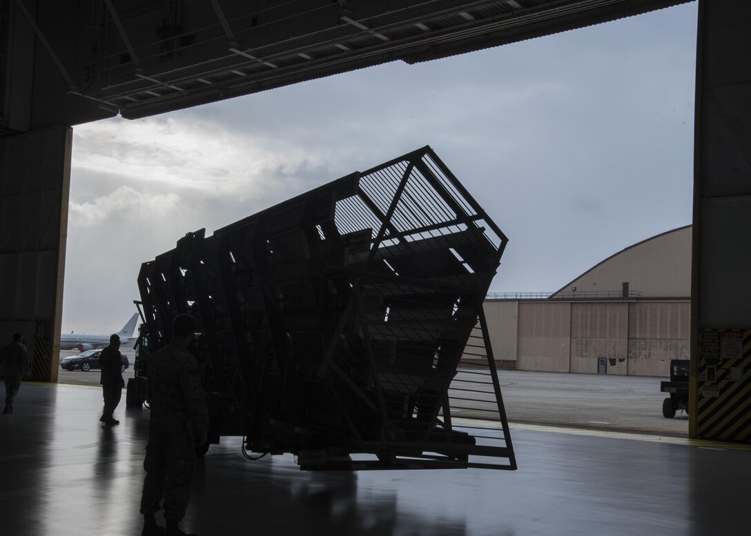 Airmen from the 11th Civil Engineer Squadron place a bleacher inside a hangar at Joint Base Andrews, Md., Feb. 16, 2017. The setup is in preparation for the Chief Master Sergeant of the Air Force Transition Ceremony scheduled for Feb. 17. During the event, Chief Master Sgt. of the Air Force James A. Cody will retire and Chief Master Sgt. Kaleth O. Wright will be appointed as the 18th Chief Master Sergeant of the Air Force. (U.S. Air Force photo by Senior Airmen Jordyn Fetter)