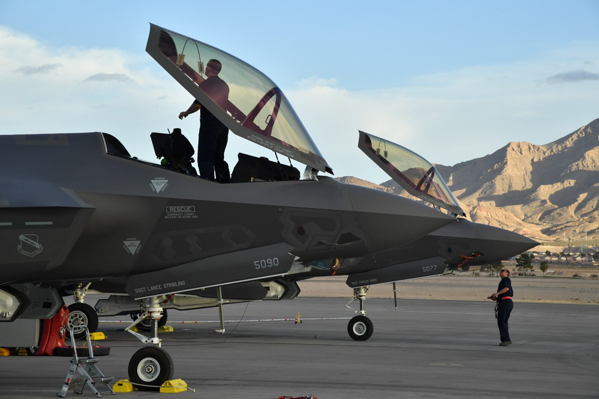 A crew chief from Hill Air Force Base, Utah, works under an F-35 Lightning II aircraft canopy during post-flight maintenance Feb. 7 during Red Flag 17-1 at Nellis Air Force Base, Nevada. (U.S. Air Force photo by R. Nial Bradshaw)