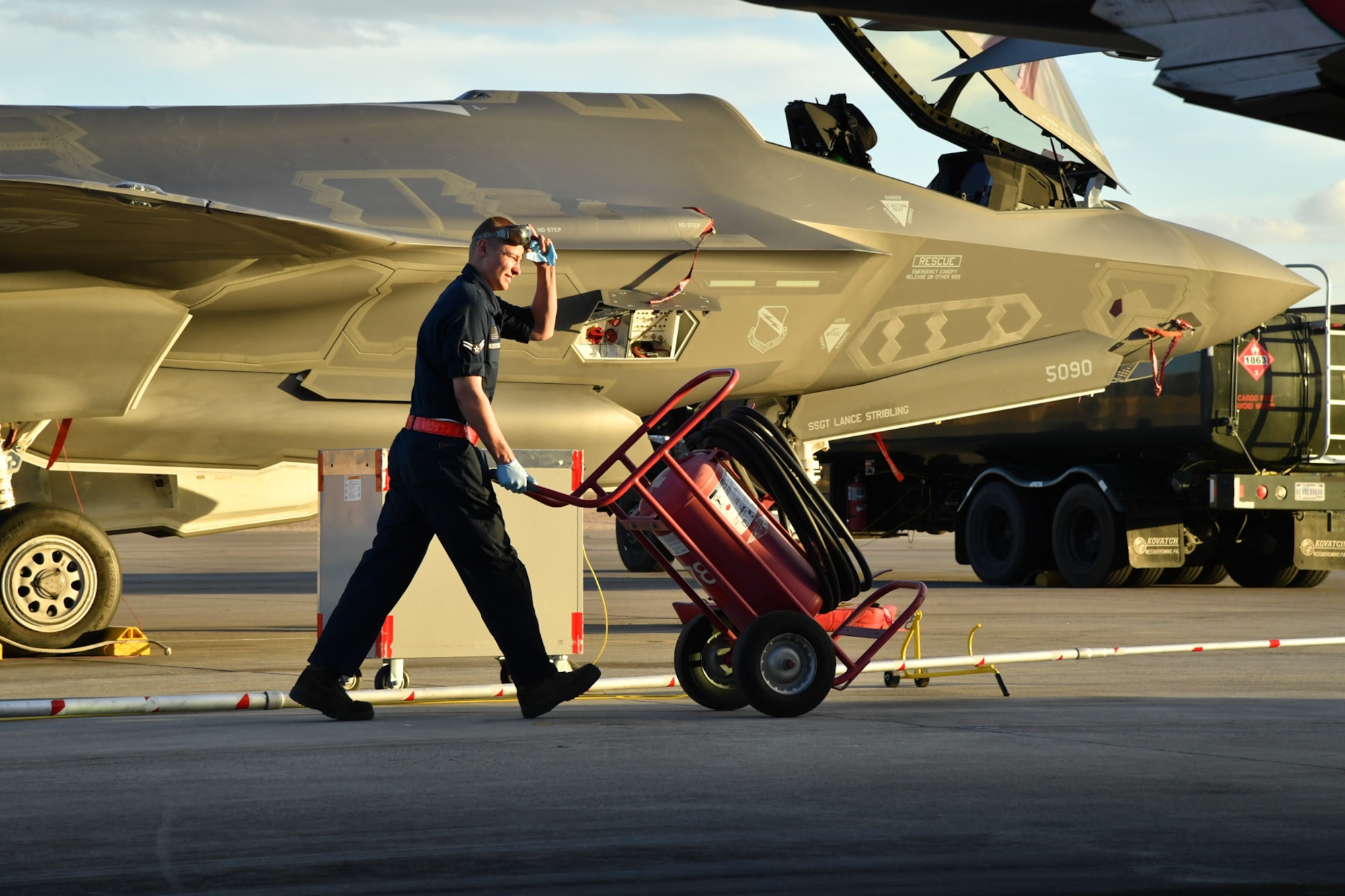 Airman 1st Class Nathan Kosters, a crew chief with the 34th Aircraft Maintenance Unit, Hill Air Force Base, Utah, moves a halon bottle while fueling an F-35A Lightning II aircraft Feb. 7 during Red Flag 17-1 at Nellis Air Force Base, Nevada. (U.S. Air Force photo by R. Nial Bradshaw)