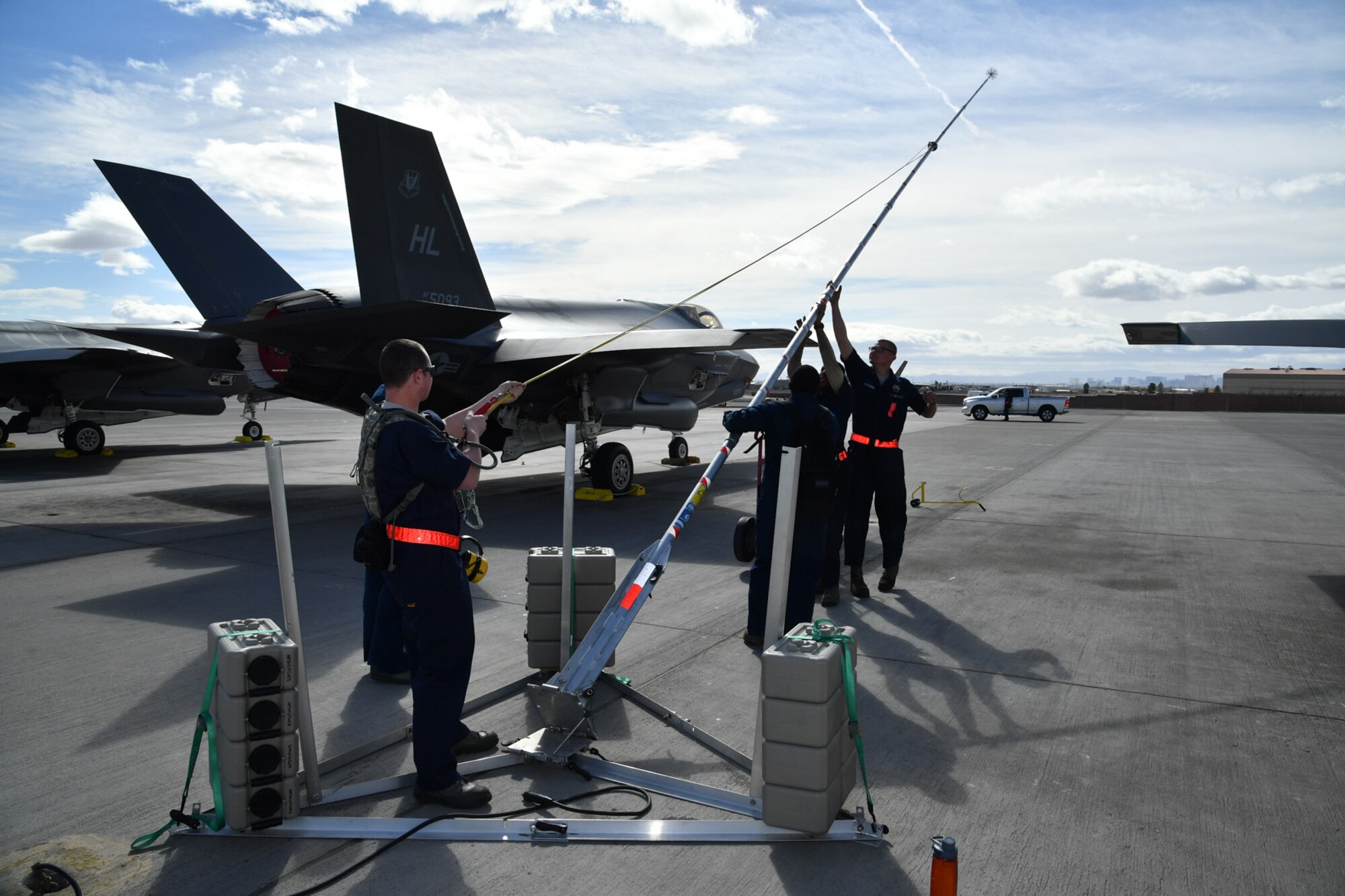 Crew chiefs from Hill Air Force Base, Utah, lower a lightning protection rod Feb. 7 at Nellis Air Force Base, Nevada, during Red Flag 17-1. (U.S. Air Force photo by R. Nial Bradshaw)