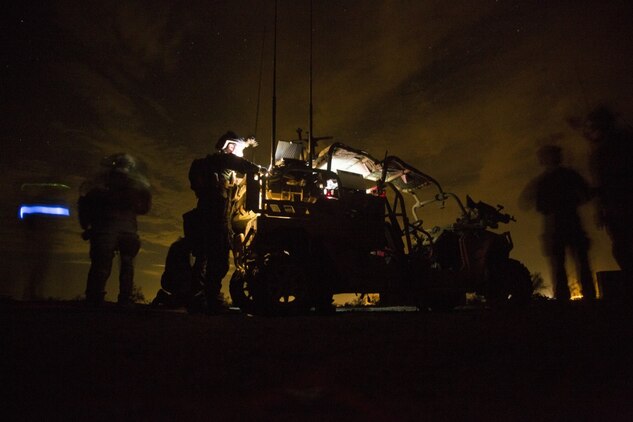 Marines with Marine Special Operations Company Charlie, 1st Marine Raider Battalion, U.S. Marine Corps Forces, Special Operations Command, process intelligence and set up a visual tele-communication feed after a simulated direct-action night raid during a company level exercise along the state line between Arizona and California, Oct. 20, 2015. Special operations are conducted in hostile, denied or politically sensitive environments, requiring heavy emphasis on combat support capabilities, modes of employment, and dependence on operational intelligence and indigenous assets. (U.S. Marine Corps photo by Cpl. Steven Fox, released)