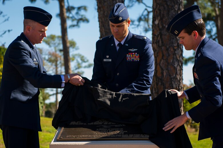 Lt. Col.Matthew Norton, left, commander of the 25th Intelligence Squadron, Lt. Col. Erick Turasz, center, commander of the 34th Special Operations Squadron, and Capt. Josiah Rawlings, acting commander of the 319th SOS, unveil the Ratchet 33 memorial plaque during a memorial ceremony at the air park, Hurlburt Field, Fla., Feb. 16, 2017. Ratchet 33 was a U-28A intelligence, surveillance, reconnaissance aircraft crewed by four Air Commandos that crashed in Djibouti, Africa, Feb. 18, 2012. The aircrew was comprised of Capt. Ryan Hall, Capt. Nicholas Whitlock, 1st Lt. Justin Wilkens and Senior Airman Julian Scholten. (U.S. Air Force photo by Airman 1st Class Joseph Pick)