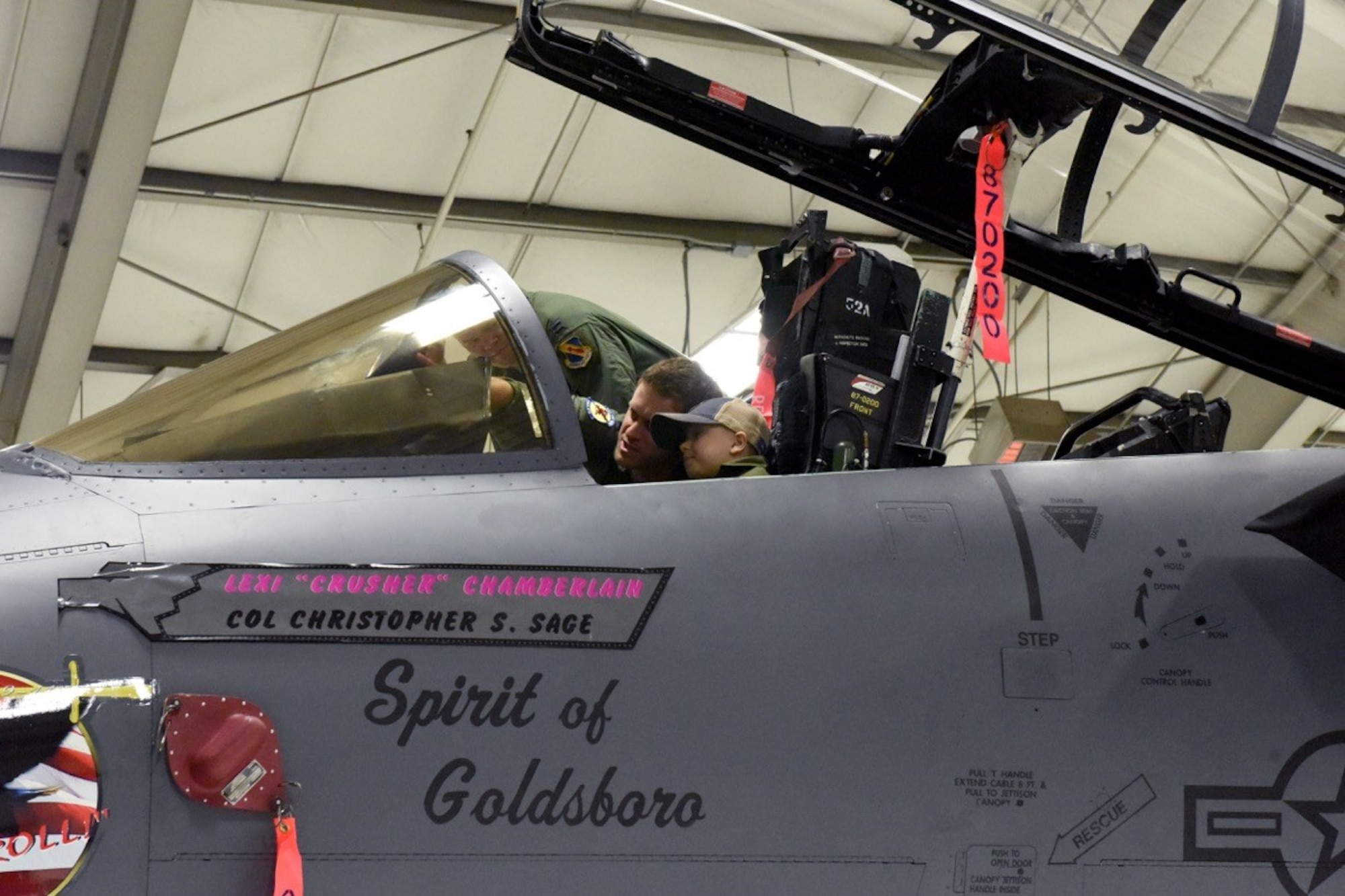Capt. Andrew Lawler, 334th Fighter Squadron pilot instructor, shows Alexis “Crusher” Chamberlain, distinguished visitor diagnosed with leukemia, the many functions of the F-15E Strike Eagle during a Pilot for a Day program event, Feb. 15, 2017, at Seymour Johnson Air Force Base, North Carolina. Lawler and Capt. Jonathan Martin, 334th Fighter Squadron F-15E Strike Eagle instructor pilots, accompanied Crusher throughout the day, answering questions and ensuring she and her family had a memorable experience at Seymour Johnson AFB. (U.S. Air Force photo by Airman Miranda A. Loera)