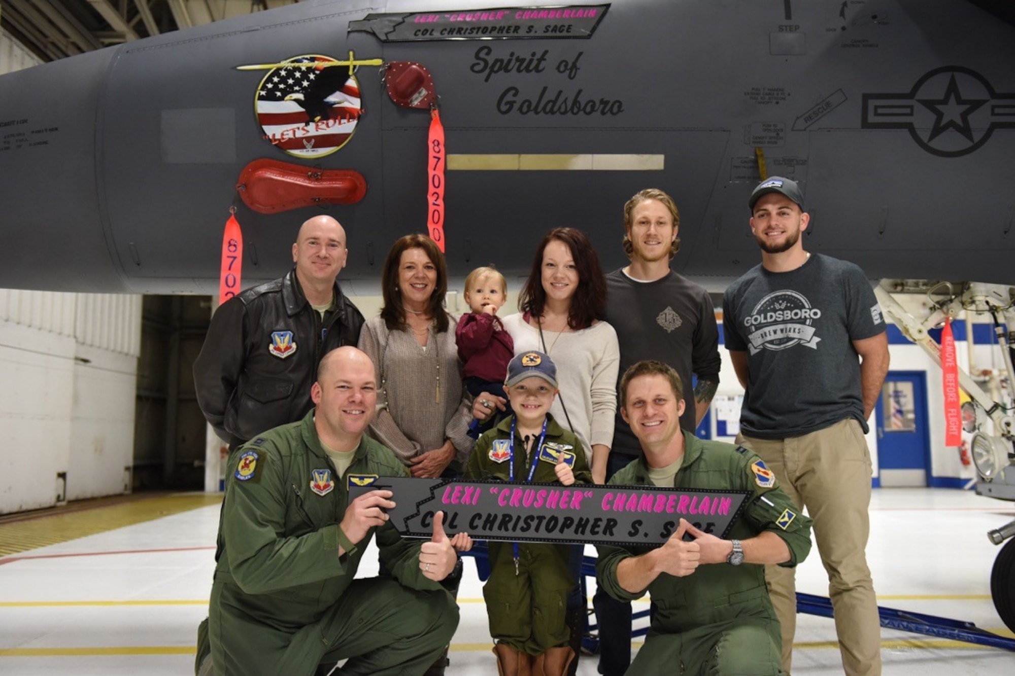 Alexis “Crusher” Chamberlain, seven-year-old leukemia patient, was chosen to spend a day as an honorary fighter pilot with the 334th Fighter Squadron, Feb. 15, 2017, at Seymour Johnson Air Force Base, North Carolina. “Crusher” said this was the first time she saw an F-15E Strike Eagle aircraft in person, but that her favorite part of the visit was the 334th FS coins she received. (U.S. Air Force photo by Airman Miranda A. Loera)